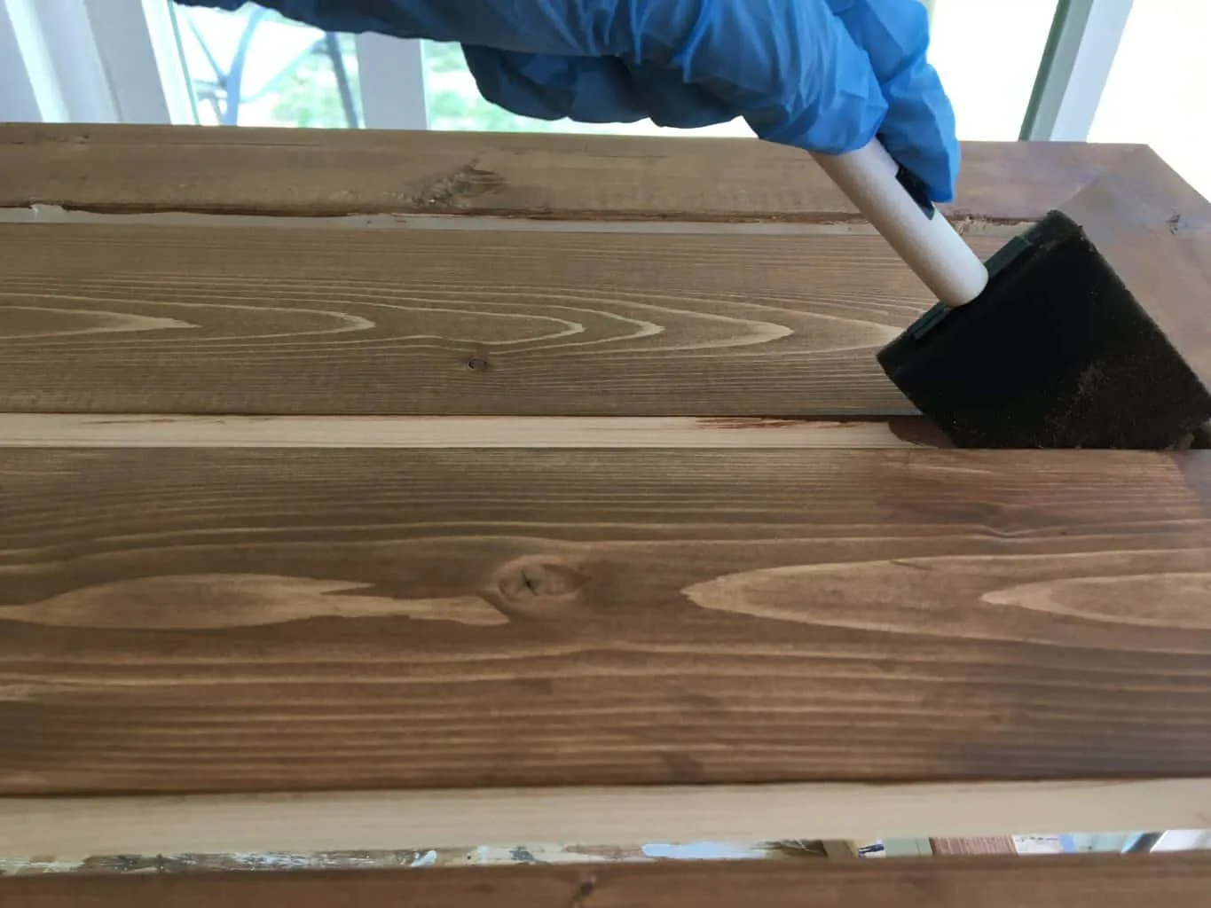 staining between wood slats with a foam brush