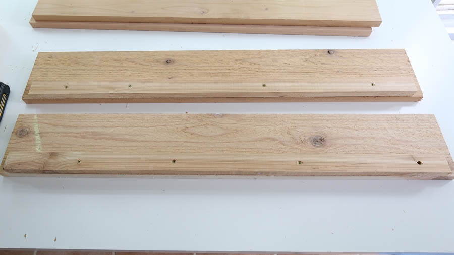 Attach the 1x2 boards to the bottom of two 1x6s with screws to create a ledge