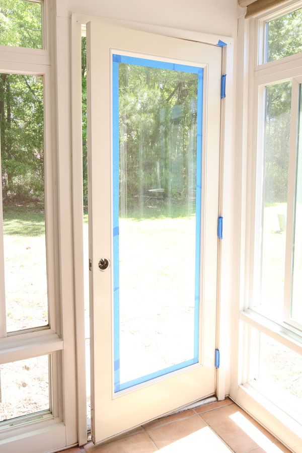 apply painter's tape around door edges for how to paint a metal door