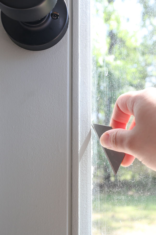 use a razor blade to remove excess paint that leaked under tape onto glass door insert