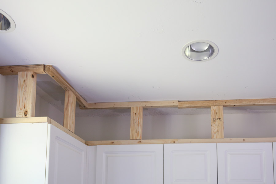 Add 2x4 wood blocks to frame boards above cabinets