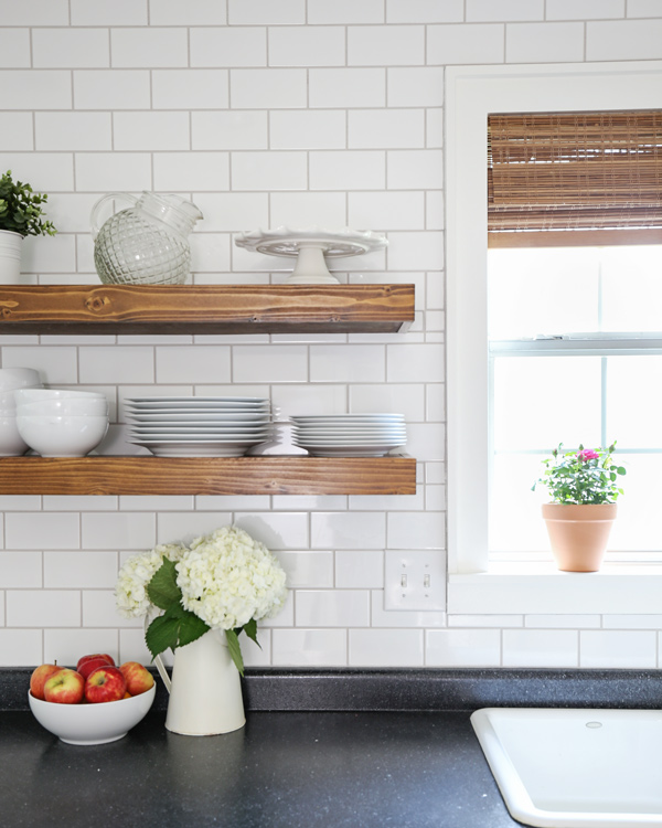 wood kithcen floating shelves and subway tile with warm gray grout