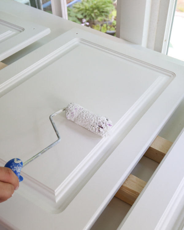 priming kitchen cabinets with a paint roller