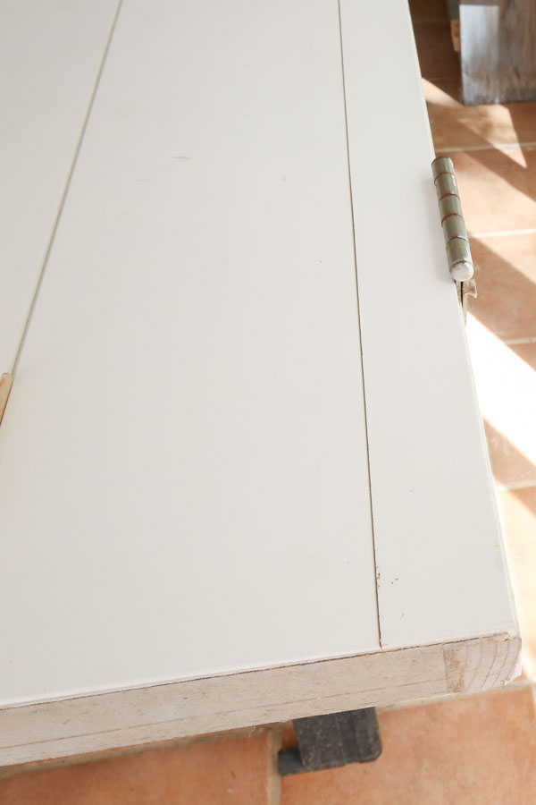 shiplap board cut to size for remaining space between boards and door hinges