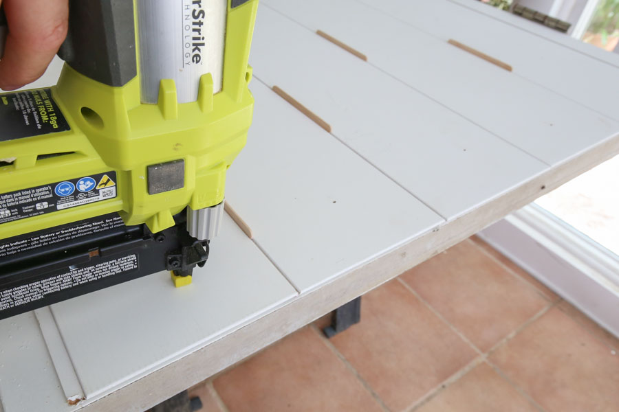 attaching shiplap boards to door with nailer