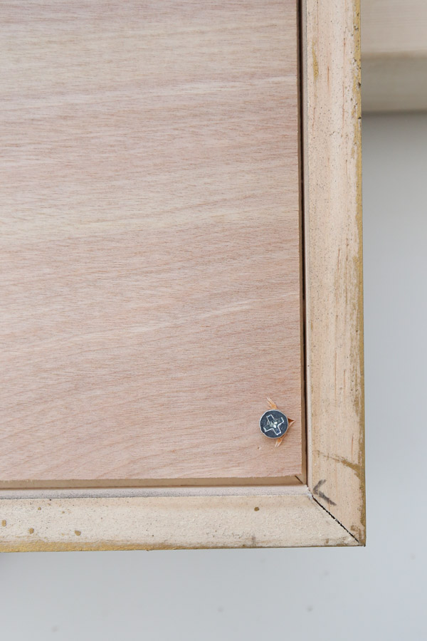 adding artwork with plywood to the back of the poster frame