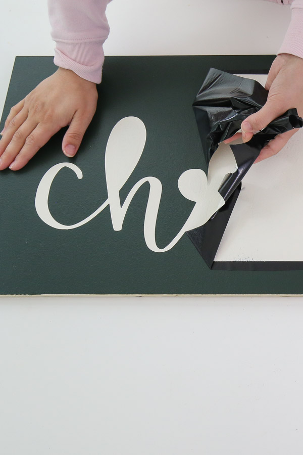 removing vinyl stencil from DIY Christmas sign