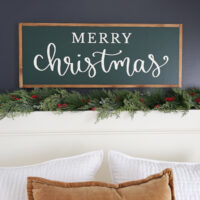 diy wooden christmas sign over bed