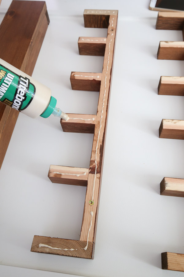 attaching the front 1x4 boards to the cubby shelves with wood glue