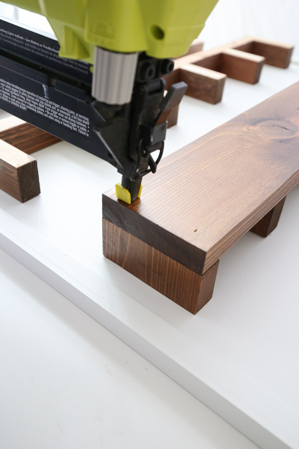 attaching the front 1x4 boards to the cubby shelves with nailer