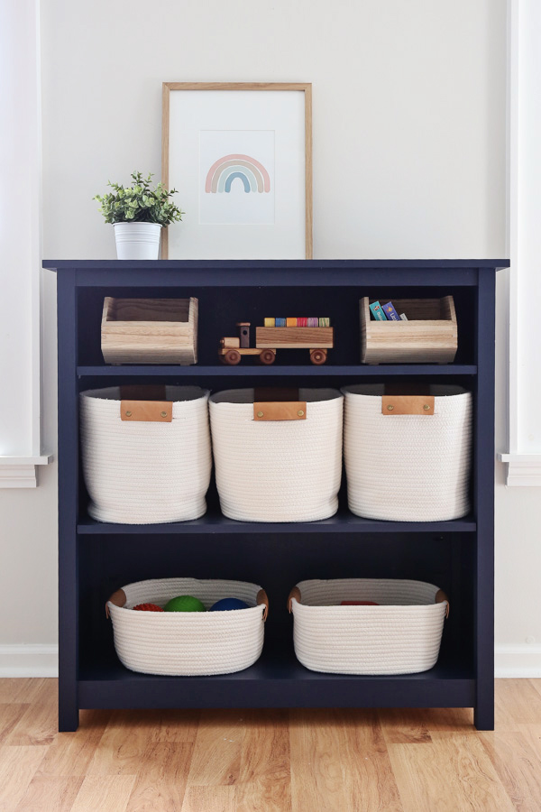 DIY kids bookshelf with storage baskets and toys