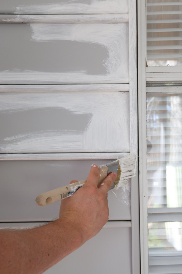 painting vinyl siding and cutting in around hard to reach areas like the window