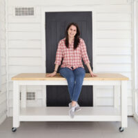 woman woodworker sitting on DIY workbench