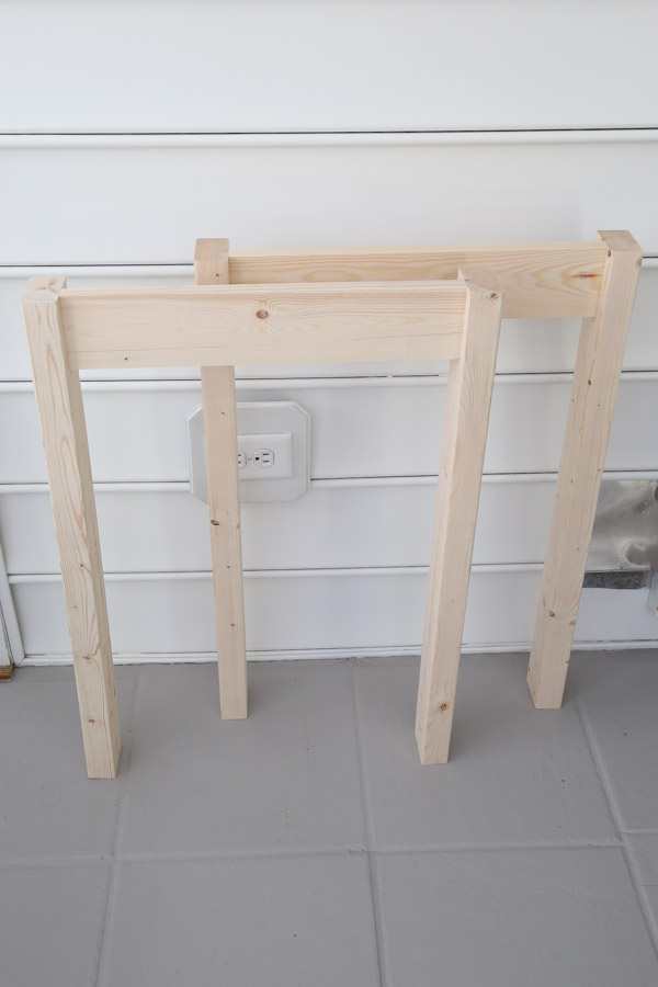 two assembled desk frame sides for DIY wood desk