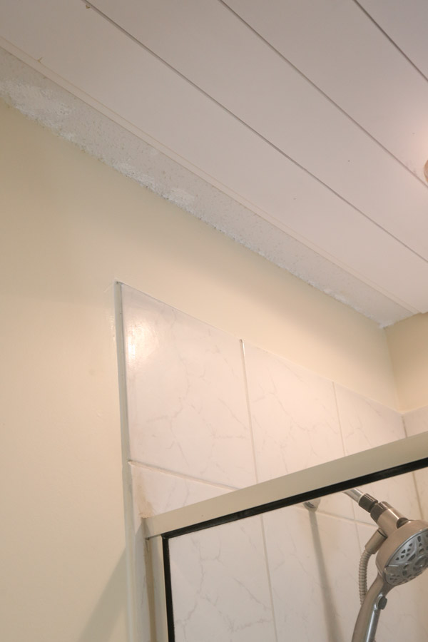 shiplap bathroom ceiling in progress with last board installation