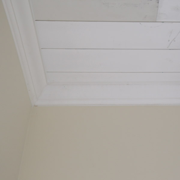 crown molding installed over shiplap ceiling edges