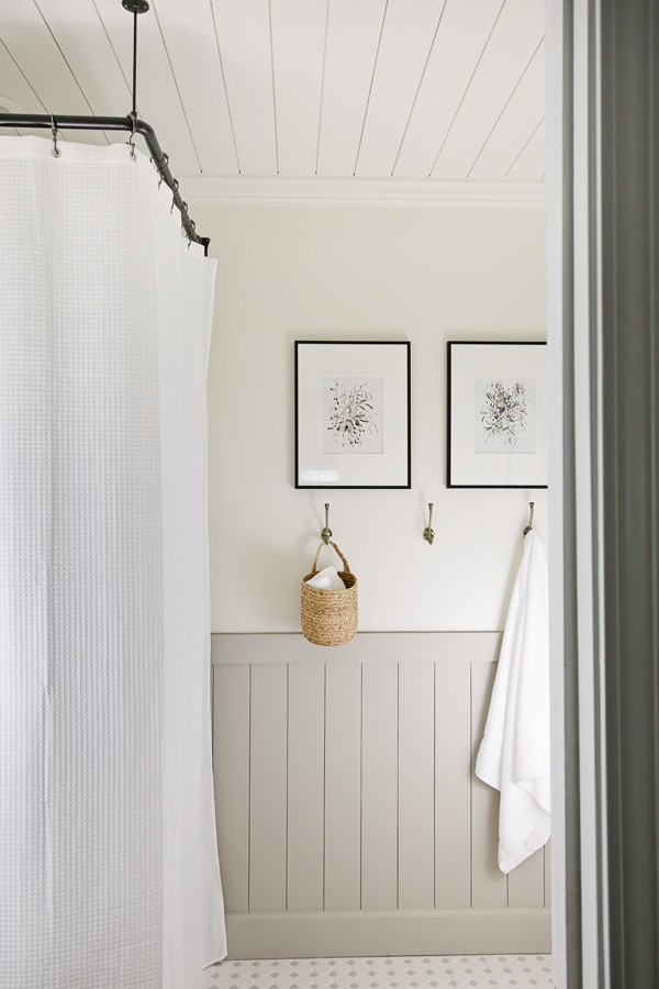 pretty corner shower curtain and rod with DIY vertical shiplap in bathroom makeover