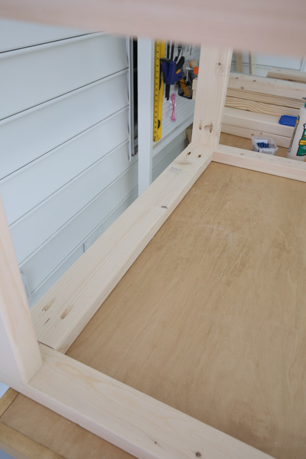 attach 2x4 with pocket holes to side frames to create the back of the cart