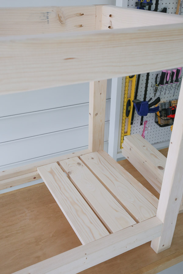 space out 1x4 slat boards to create lower shelf