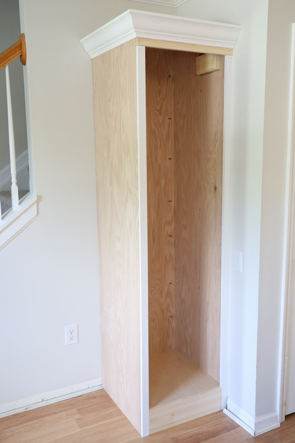 diy built in cabinet trimmed out with crown molding before adding cabinet door