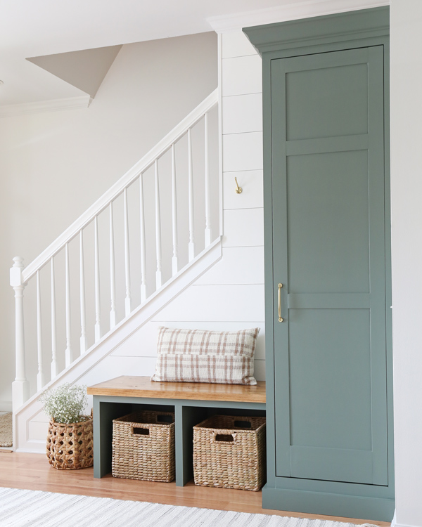 Stair railing painted white, sherwin williams retreat cabinet, and wood stained top on entryway bench