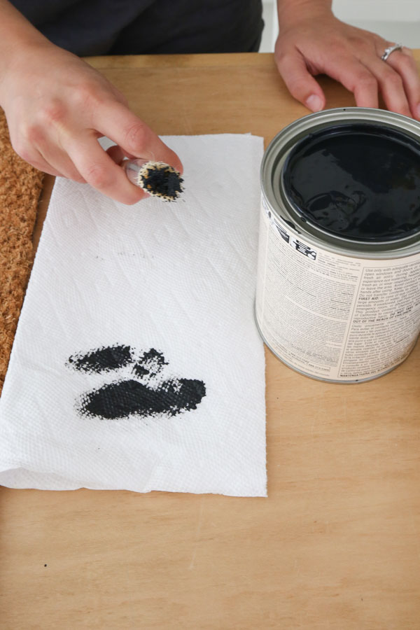 removing excess black paint from stencil brush