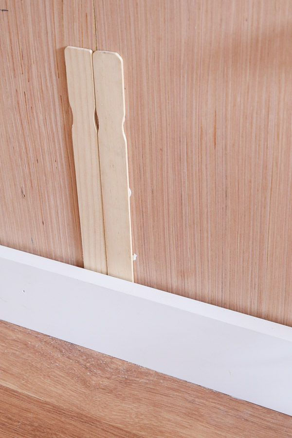 shimming behind batten board with paint sticks