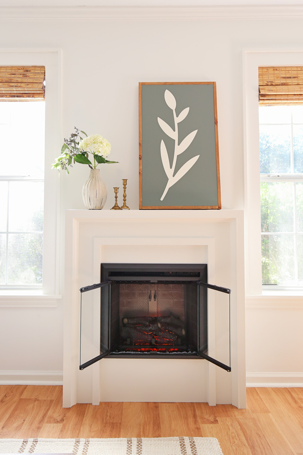 Large DIY wood sign on DIY fireplace with electric insert