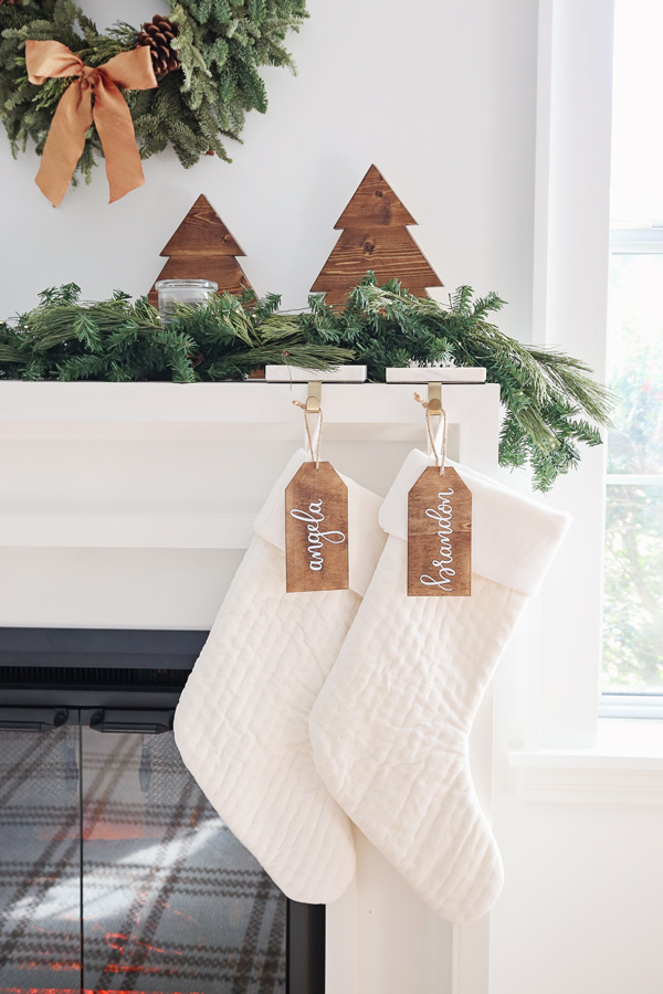 white velvet stockings with wood stocking name tags on fireplace mantel