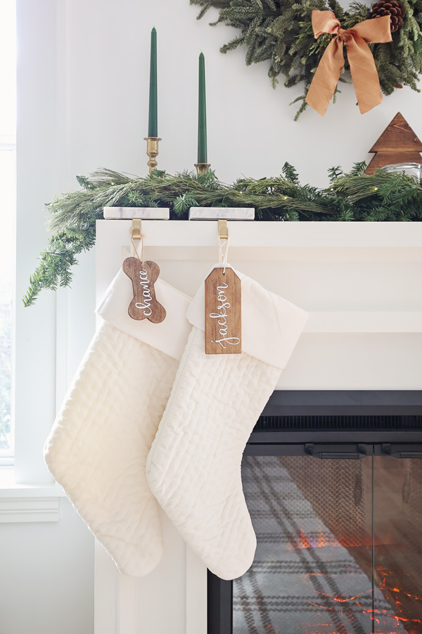 white velvet stockings with wood stocking name tags on fireplace mantel