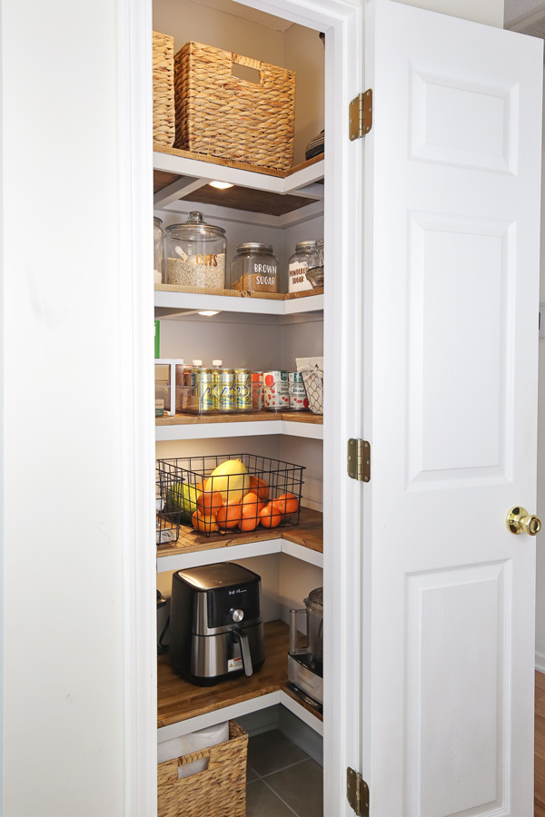 corner pantry makeover with 5 wood pantry shelves