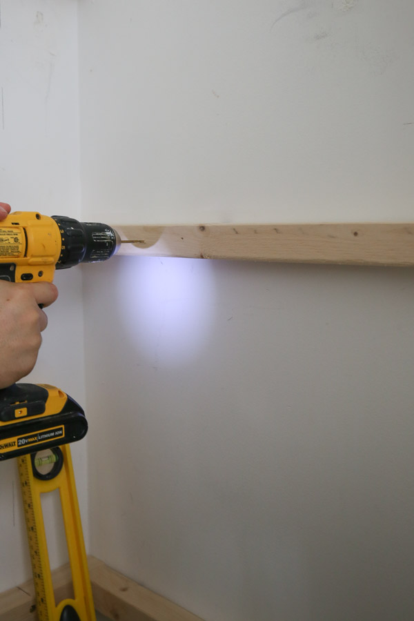 drilling pilot hole for wall anchor into 2x2 pantry shelf support