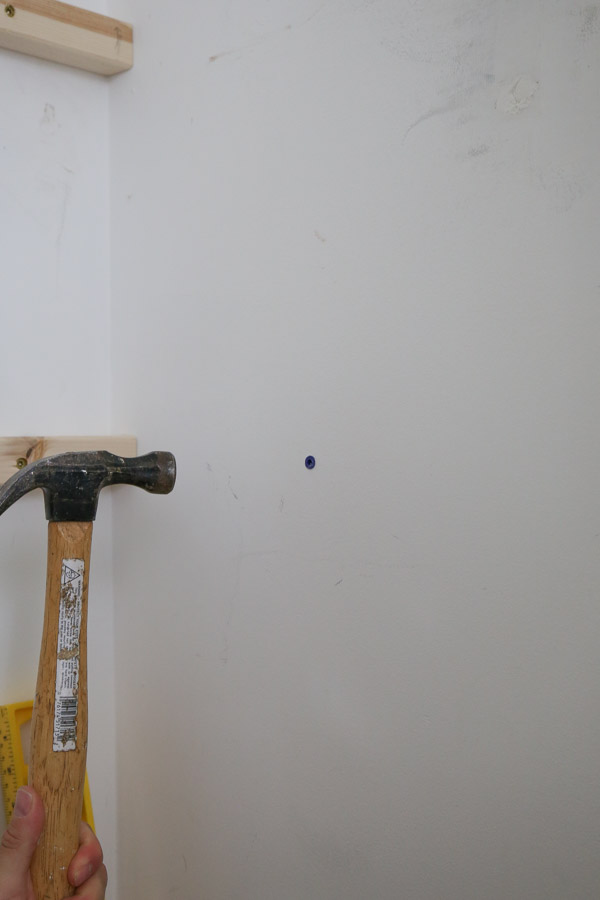 tapping wall anchor into place