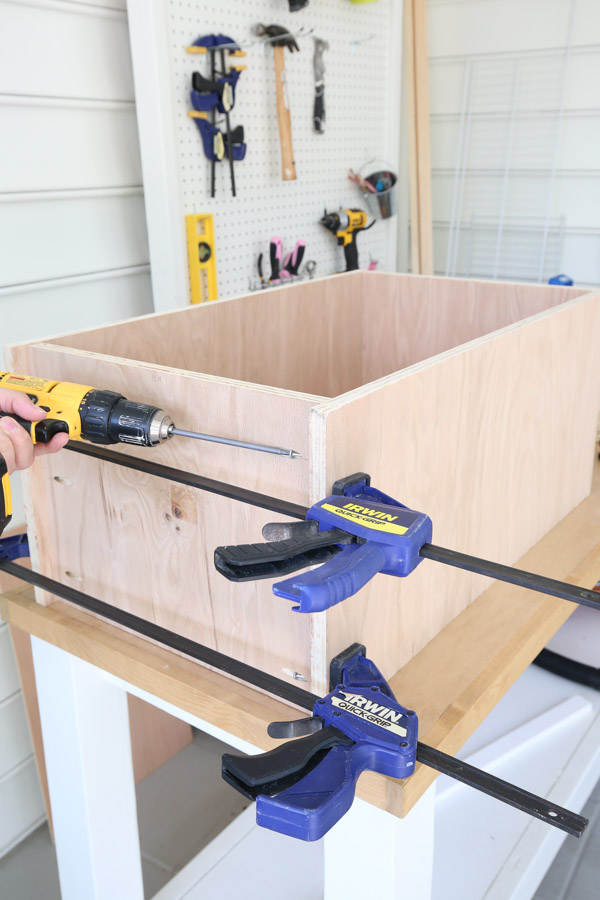 attaching bottom of cabinet to sides of cabinet carcass