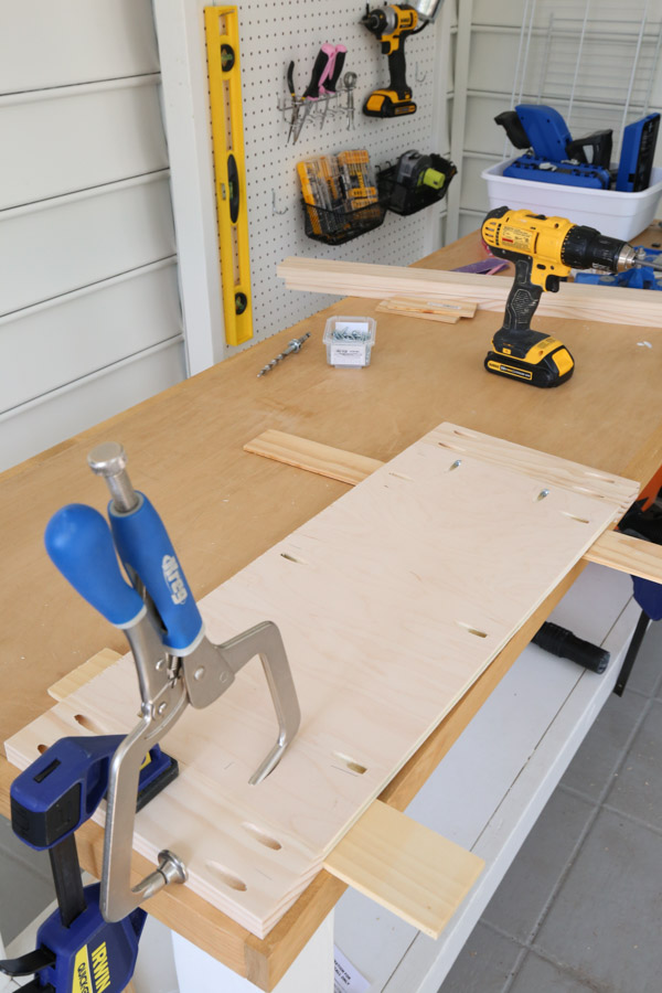 using clamps, kreg screws, and wood glue to assemble DIY cabinet door