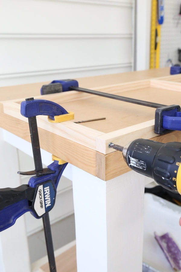 using a drill to assemble frame of the floating shelf diy