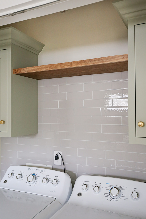 thin floating wall shelf DIY between cabinets in laundry room