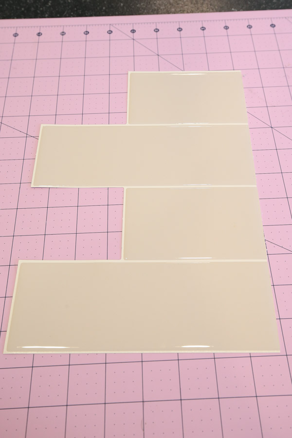 piece of adhesive tile cut to size