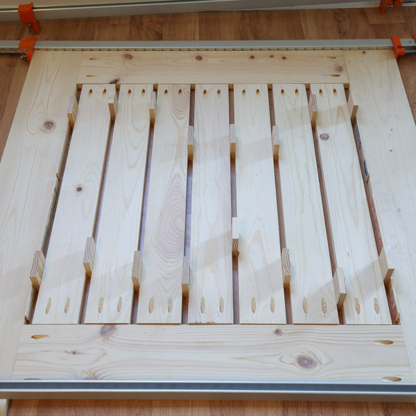 back of table top clamped together with slat boards and spacer blocks