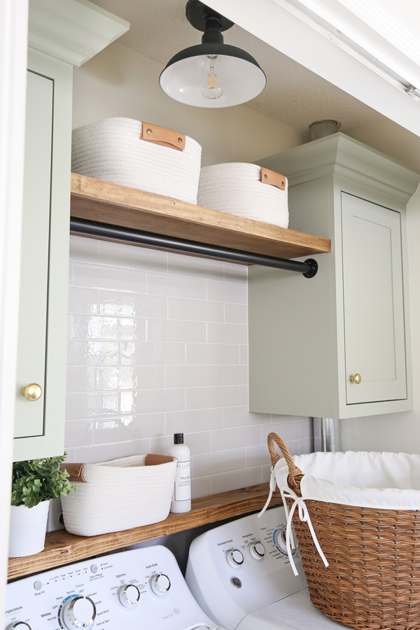 DIY closet laundry room makeover reveal with barn ceiling light, cabinets, baskets, and shelves