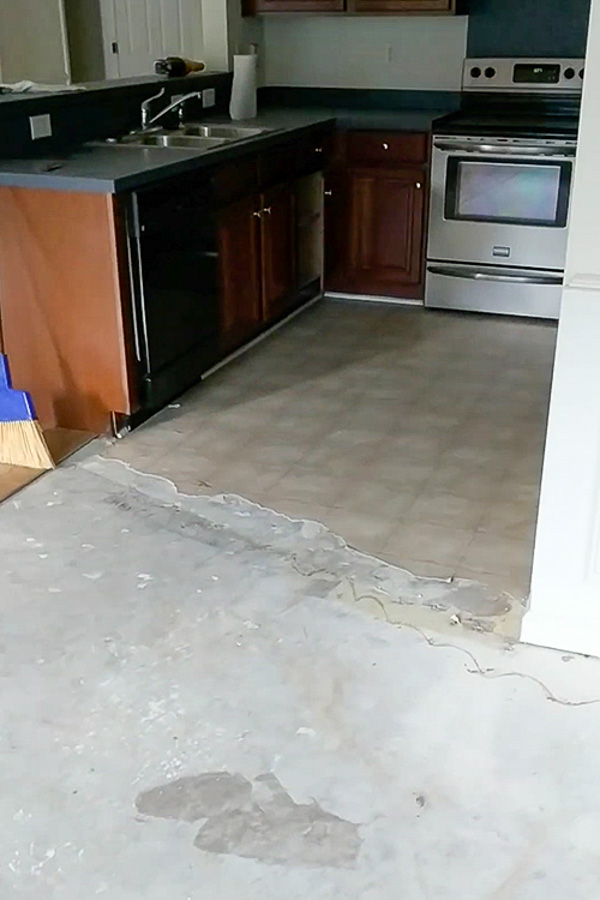 old vinyl sheet flooring in kitchen during demo