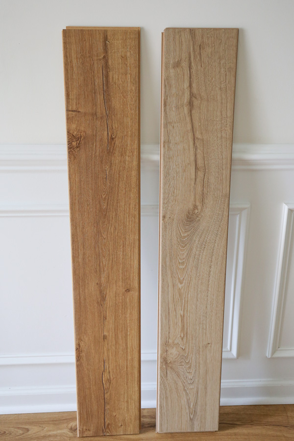 two sample boards of pergo outlast laminate flooring in marigold oak and vienna oak