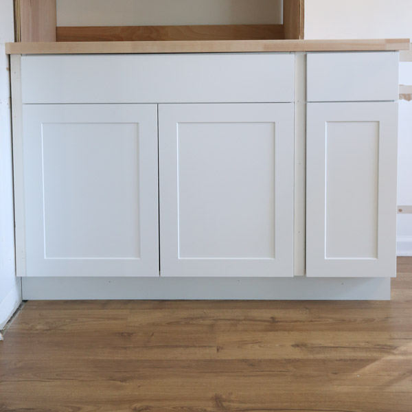 diy built ins with stock cabinets installed with 1x2 side trim and toe kick