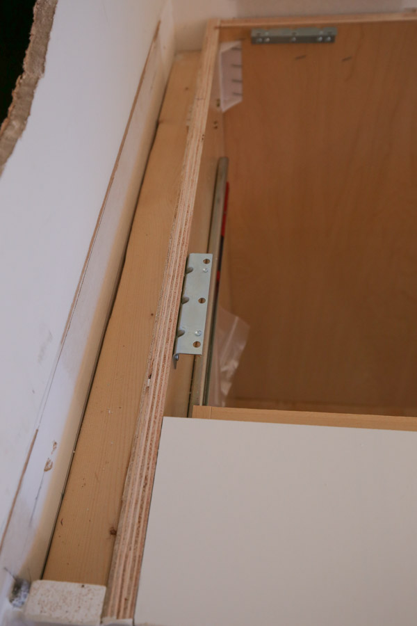 corner brackets installed to base cabinets for attaching butcher block to cabinets