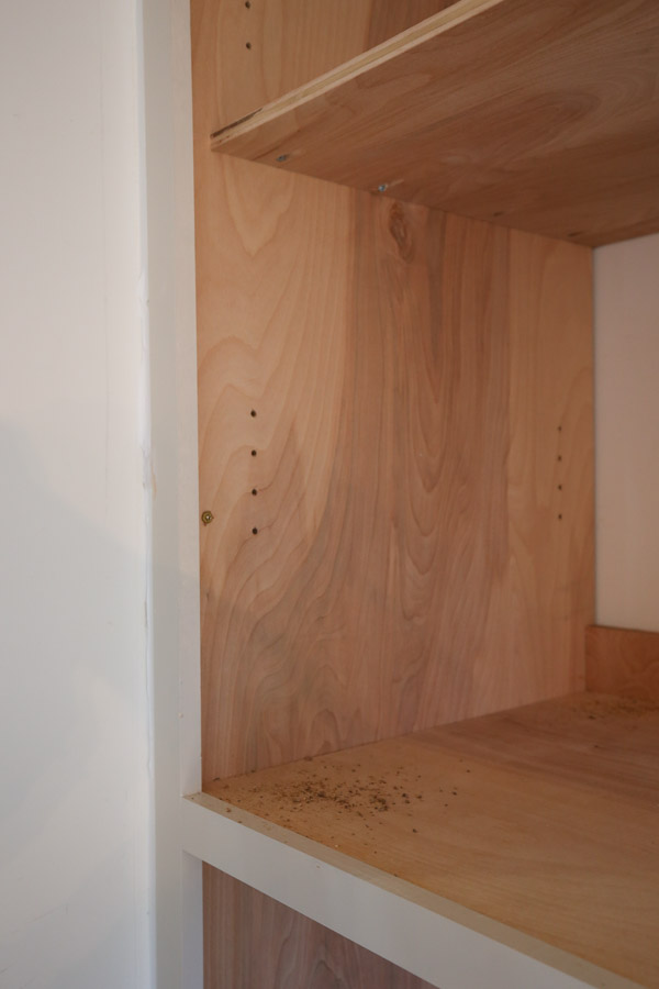 shelf pin holes drilled with jig on inside of cabinet