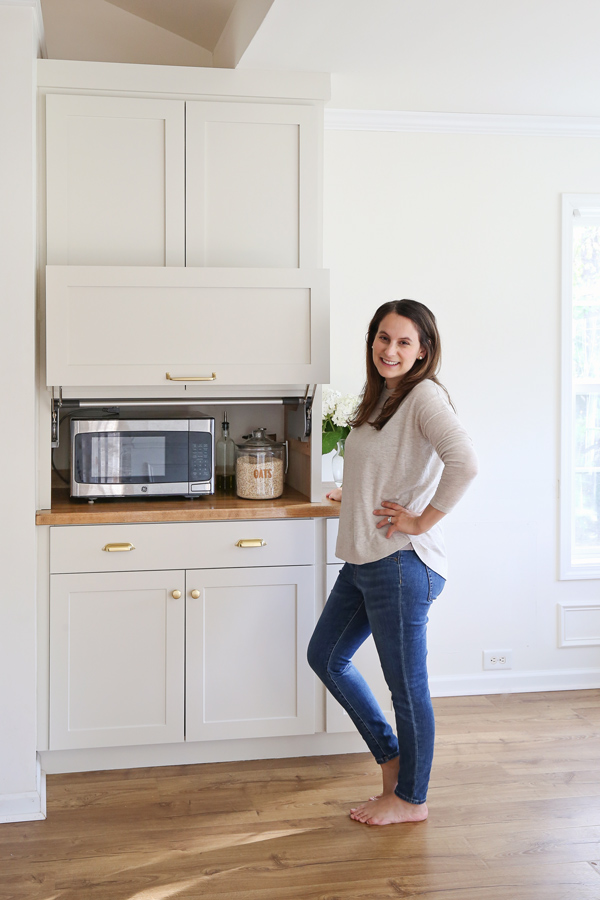 woman DIYer standing next to kitchen appliance garage DIY