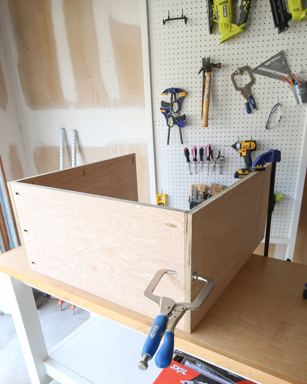 add other side of DIY garage cabinet frame with clamps and kreg screws