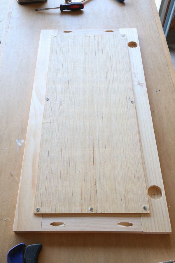 1/4" plywood backing board attached to the back of the cabinet door frame