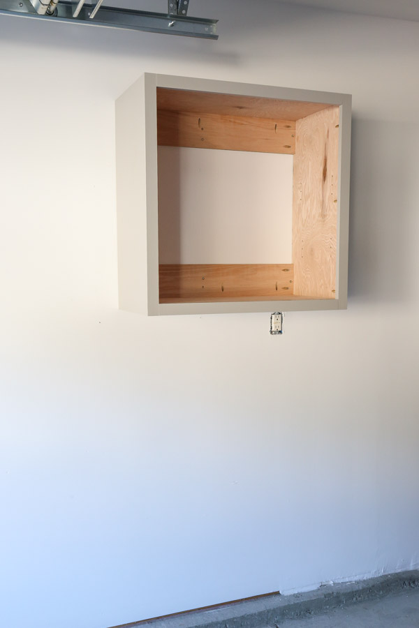 diy garage wall cabinet installed on garage wall before adding doors