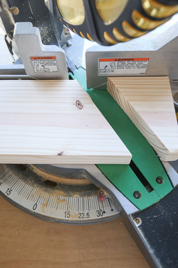 Cut the largest base board of the DIY Wooden Christmas Tree with a miter saw